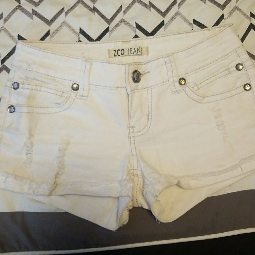 Distressed white jean shorts